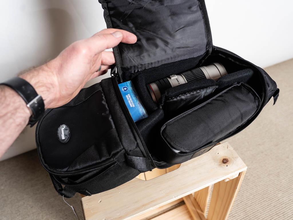 A photo of the interior of the Ultimax sling backpack with camera equipment.
