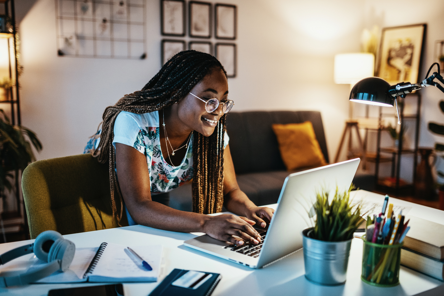 Woman working on a MacBook in her living room.